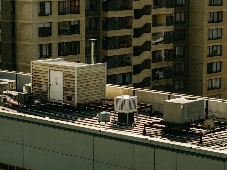 Flat commercial roof carrying air handling plant behind a parapet