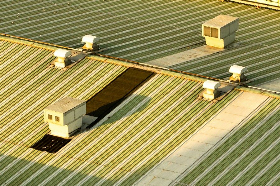 Profiled metal roof on a commercial building, with rooftop ventilation units